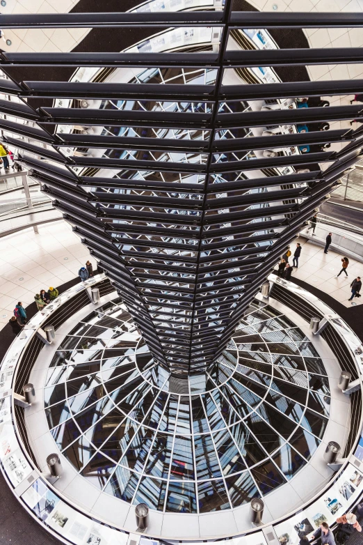 a view of a large glass building through an escalator