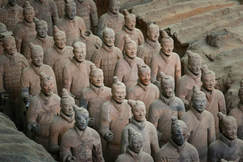 some very large statues with heads full of men