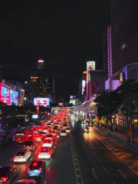 there are cars that are parked on the street in the night