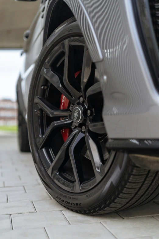 the tire and wheel of a silver car