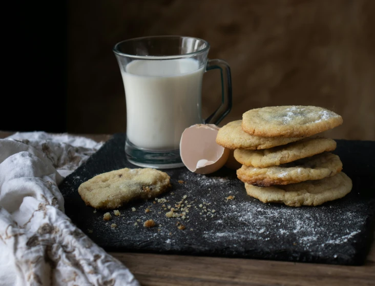 a few cookies and milk next to a glass