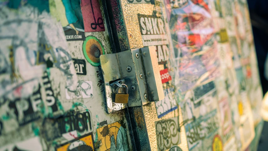 the door handle of a multicolored suitcase has stickers and symbols on it