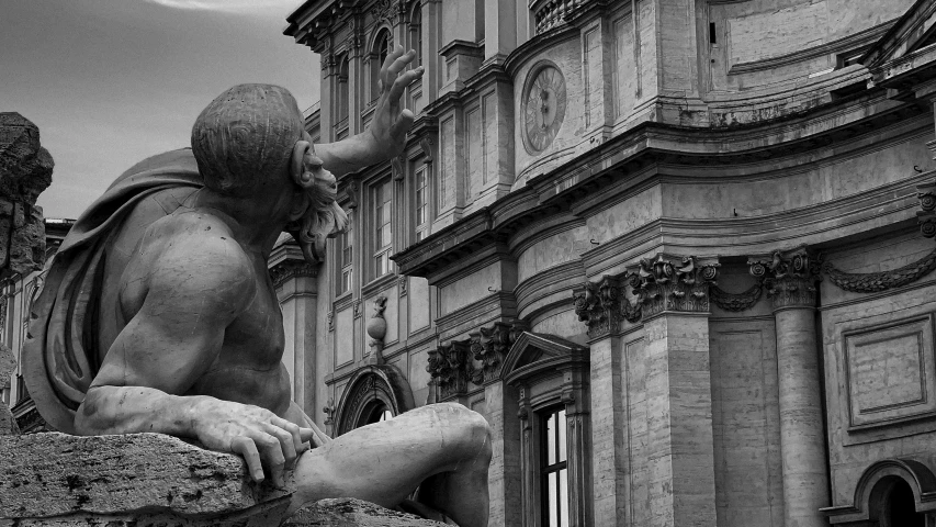 a black and white image of a statue outside