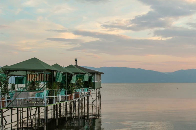 the wooden pier has many chairs on it