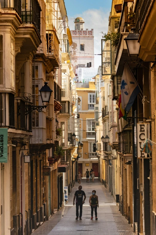 a man and a woman walking down the middle of an alley