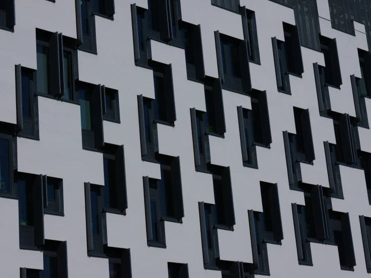 white, black and gray building with a plane in the air