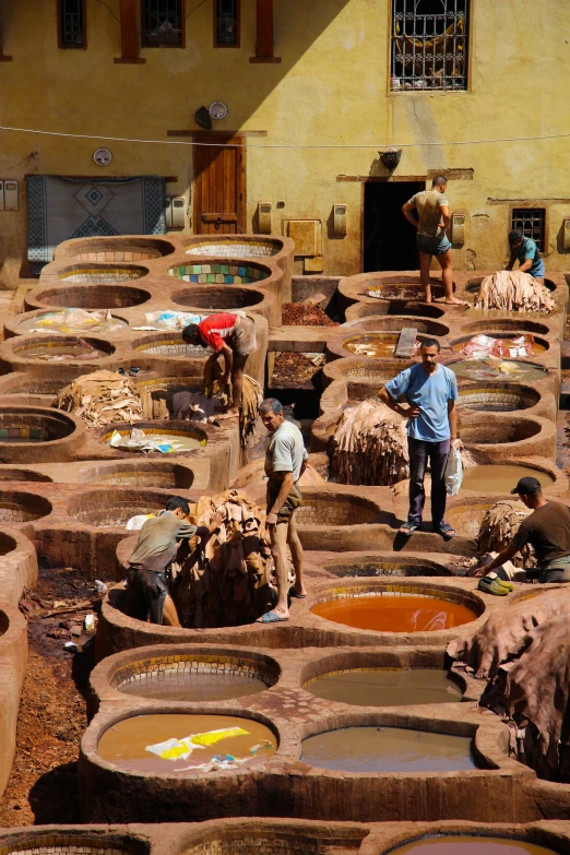 people are in an old mud oven yard