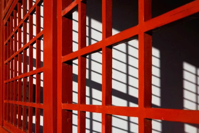 shadows cast on the wall behind the red door