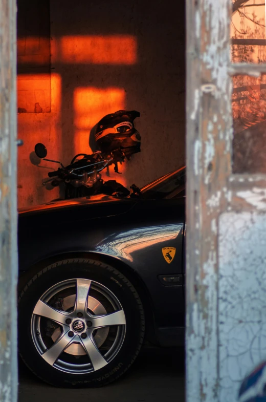 a black car parked in a garage with its hood up