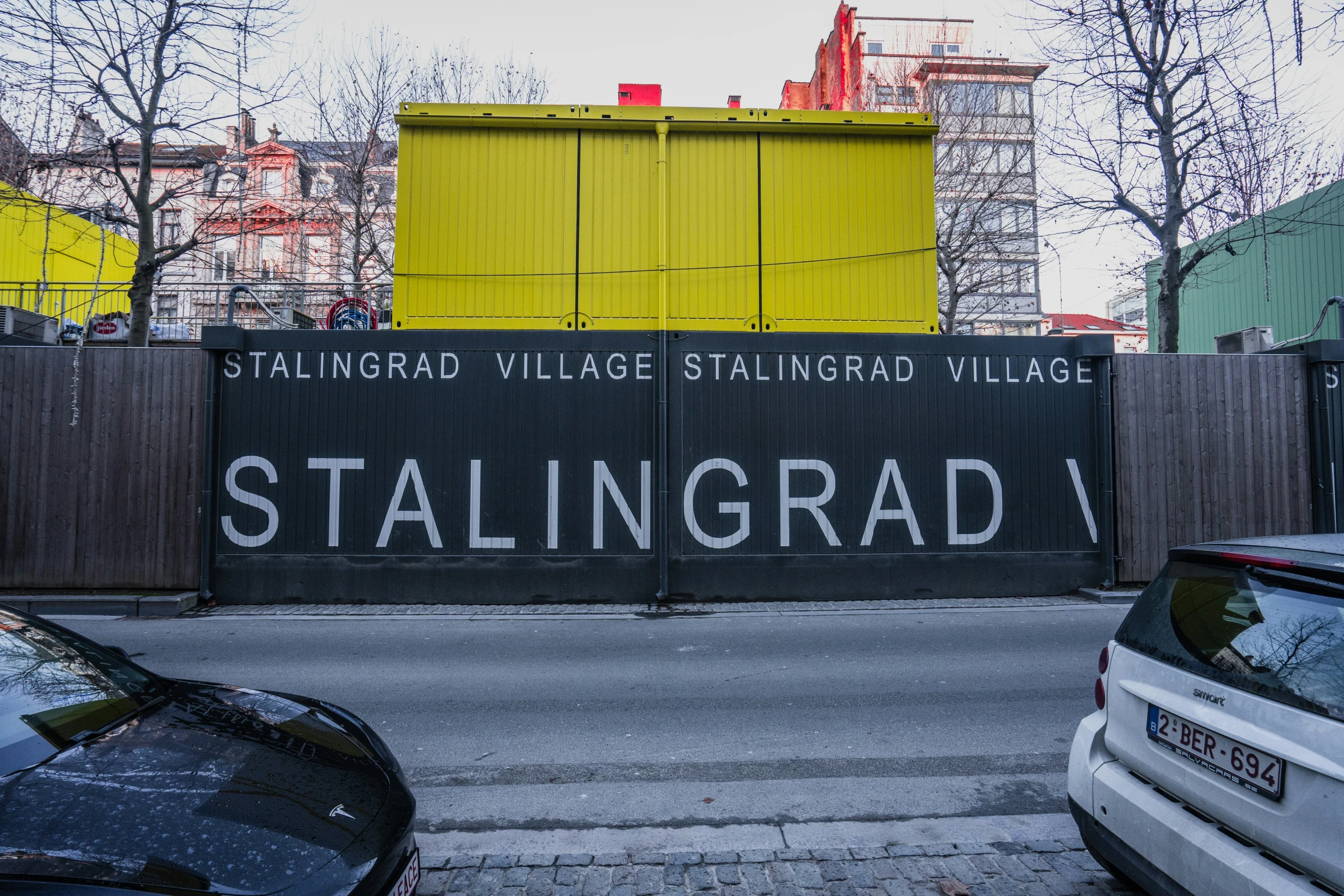 a building with a yellow fence behind it