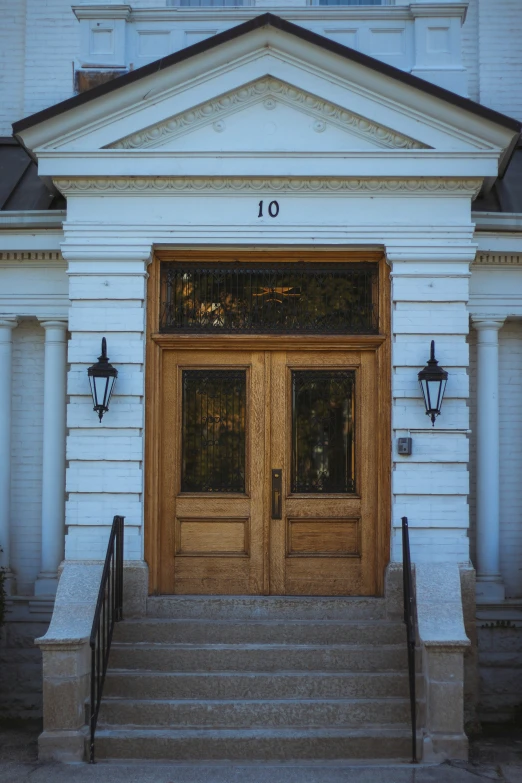 the entrance to a building with two brown doors