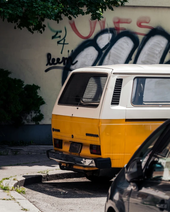 a van parked next to a curb with graffiti on it