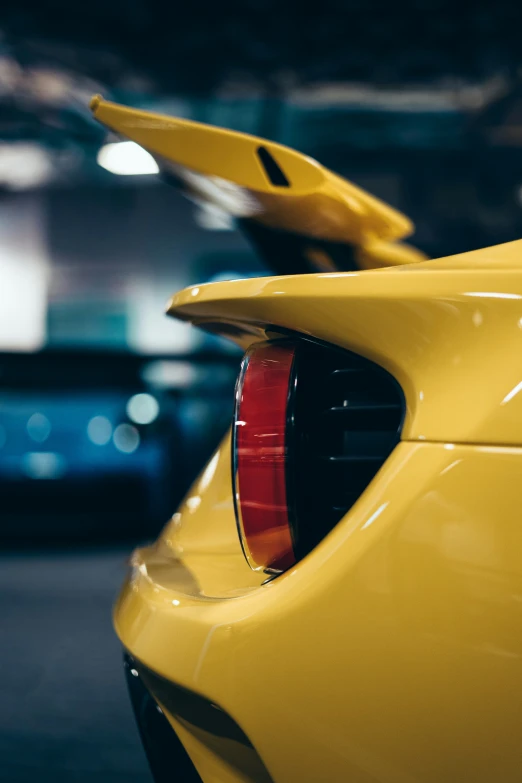 there is a yellow sports car parked next to other cars