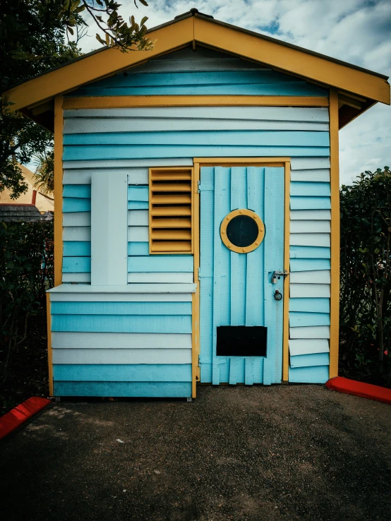 a blue house with yellow trim and a wooden door