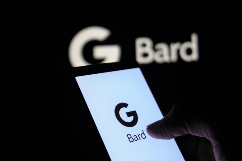 hand holding smart phone with logo on screen and the word g, band
