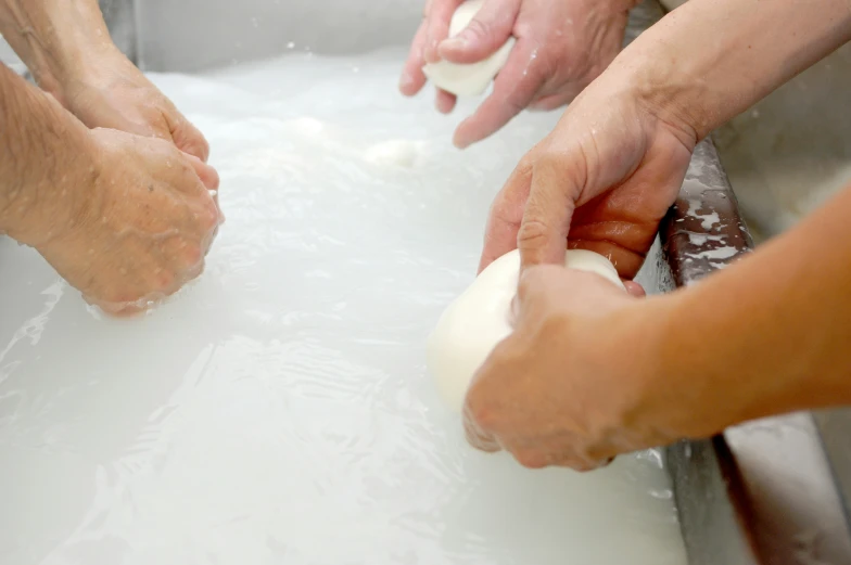 a person is rolling ingredients out from a bowl