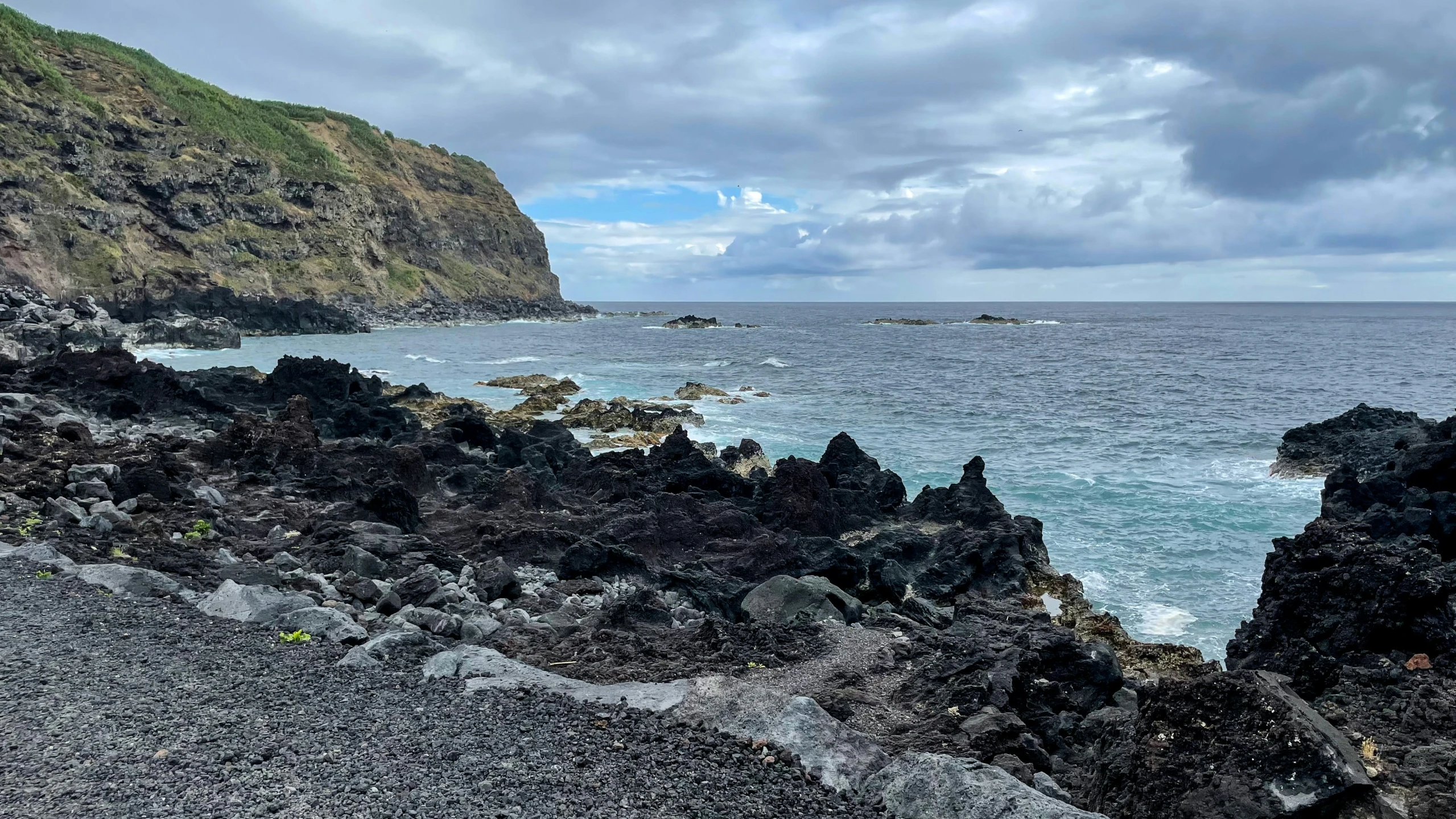 a very rocky beach by the water