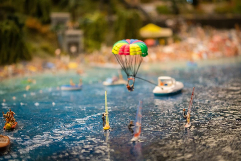 toy people on miniature boats in the water near shore