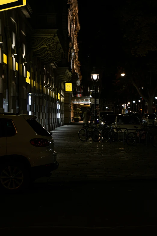 a car parked on the side of a road at night