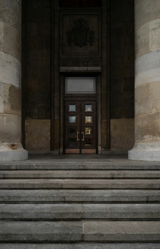 a man sits on the stone steps to the entry way