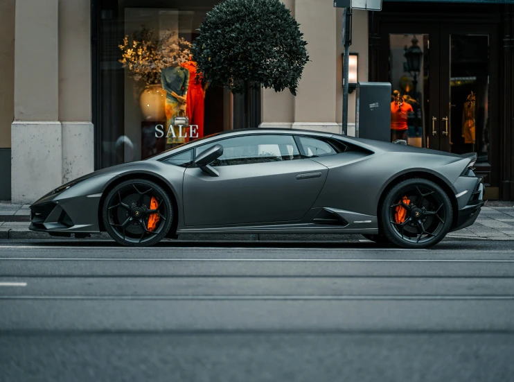 an expensive car parked on a city street