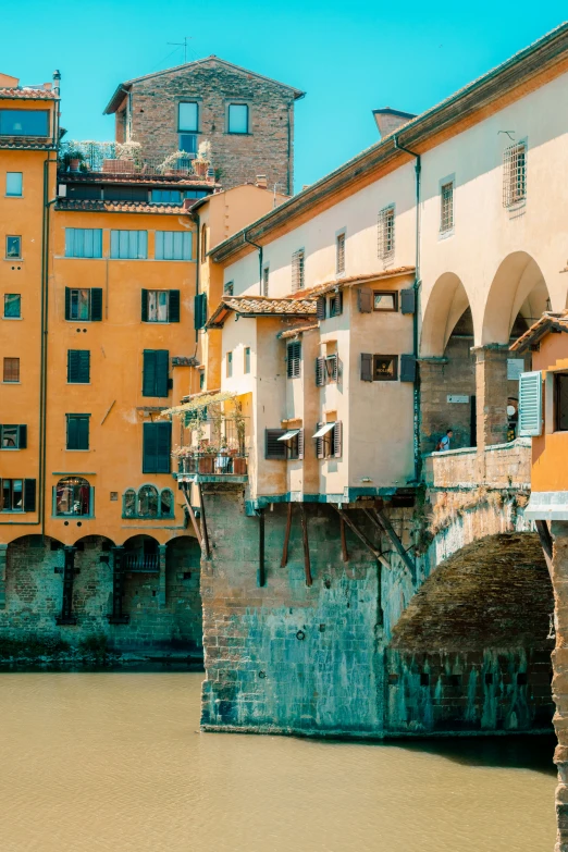 an orange building in the background, with the river running below