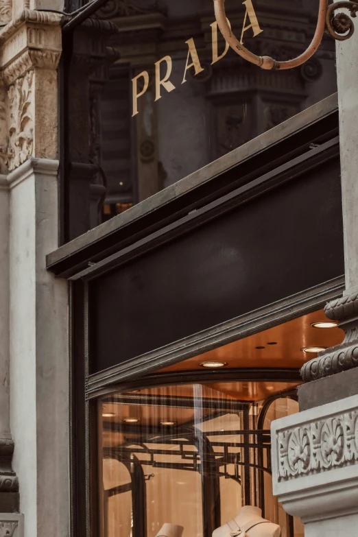 a store front with brown leather chairs in front