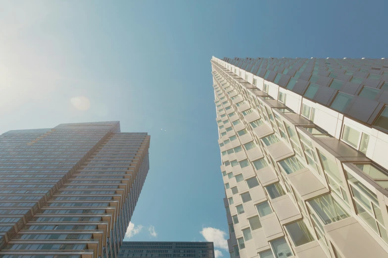 two buildings that are near each other under a blue sky