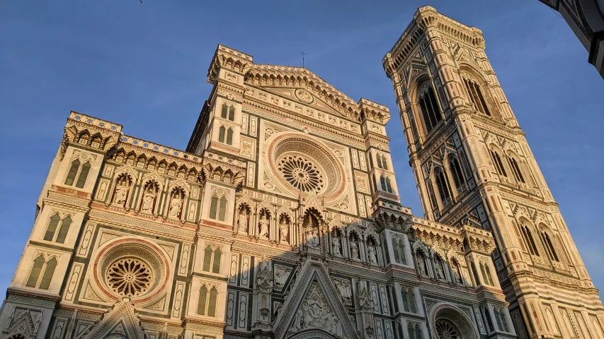 two towers are towering over an area near other buildings