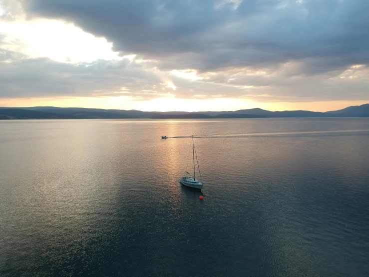 a boat on the water with some clouds