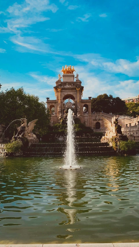 a fountain in a park with water running down the center