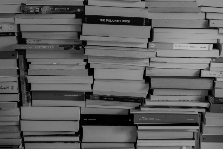 several stacks of books stacked together in a room