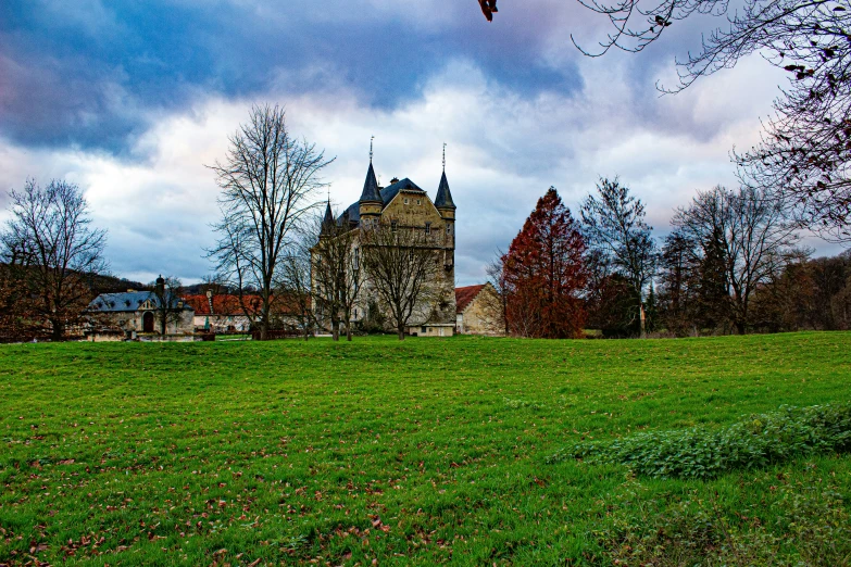 a large castle sitting next to a lush green field