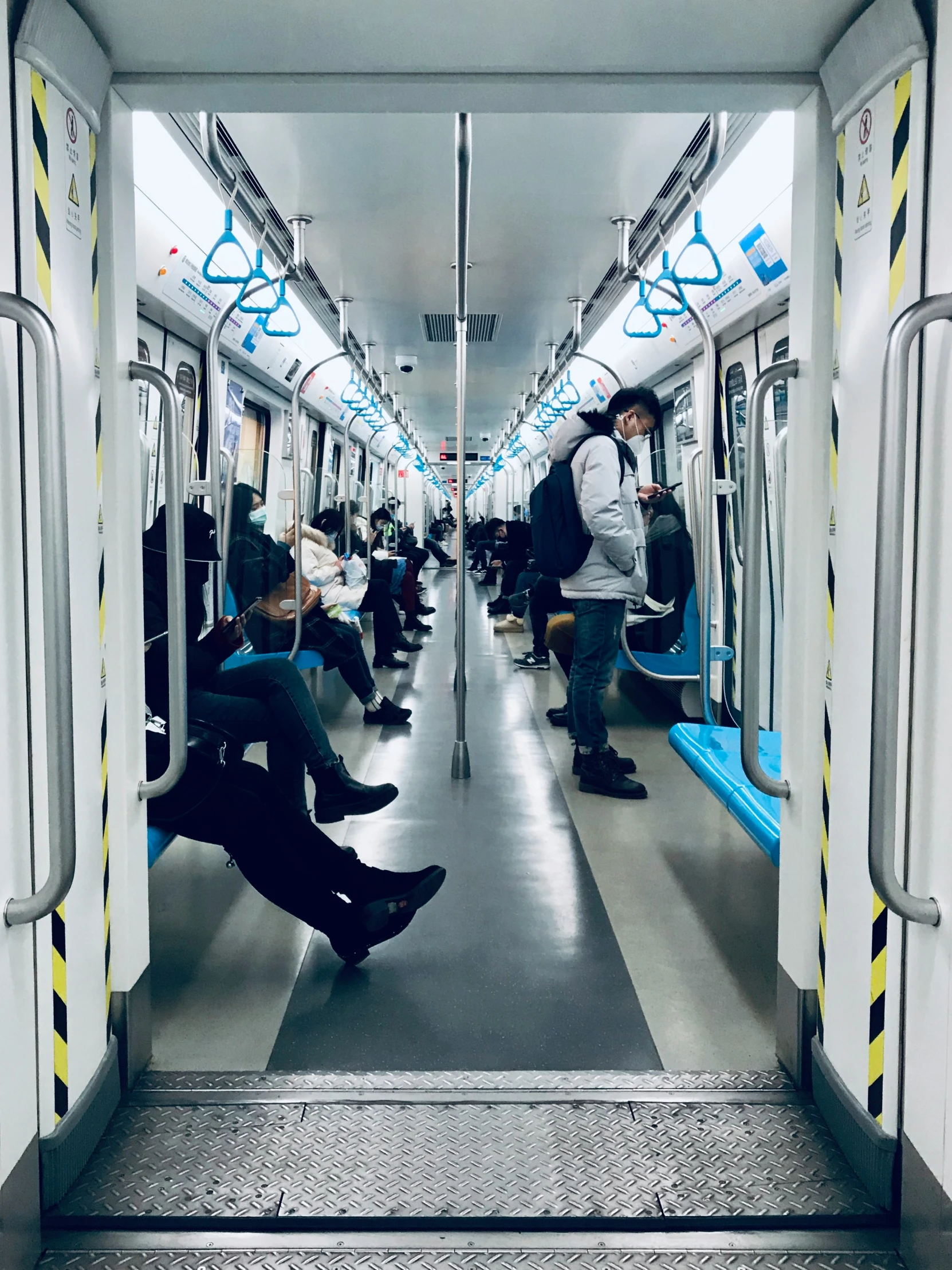 commuter train with open doors and seats during the day