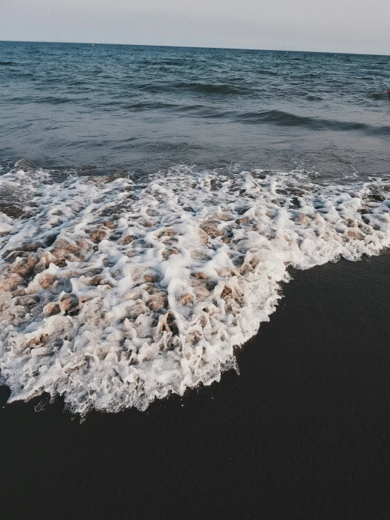 ocean water and sandy shore in the daytime