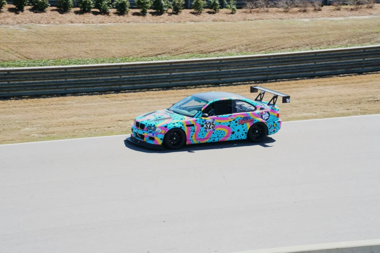 a car is driving in the desert and covered with graffiti