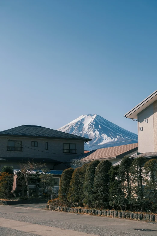 a house near mountains with a sky background