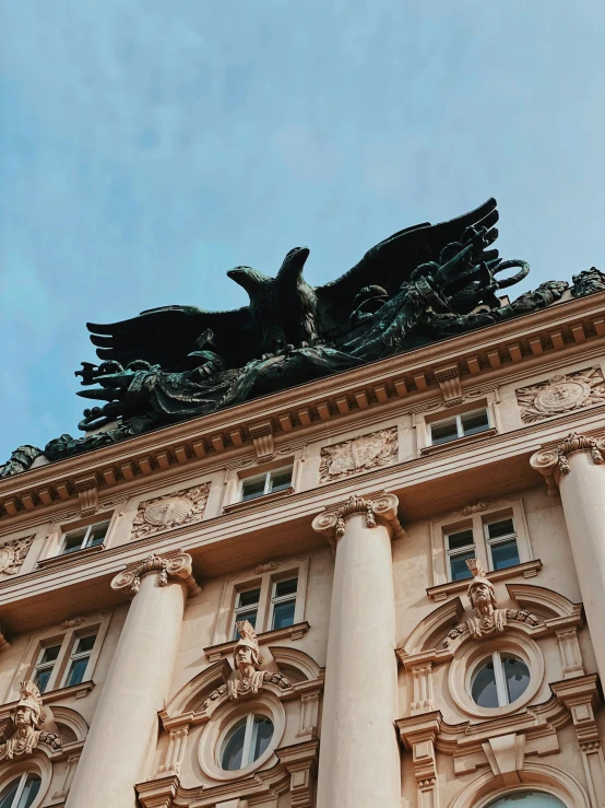 a stone building has a statue on top