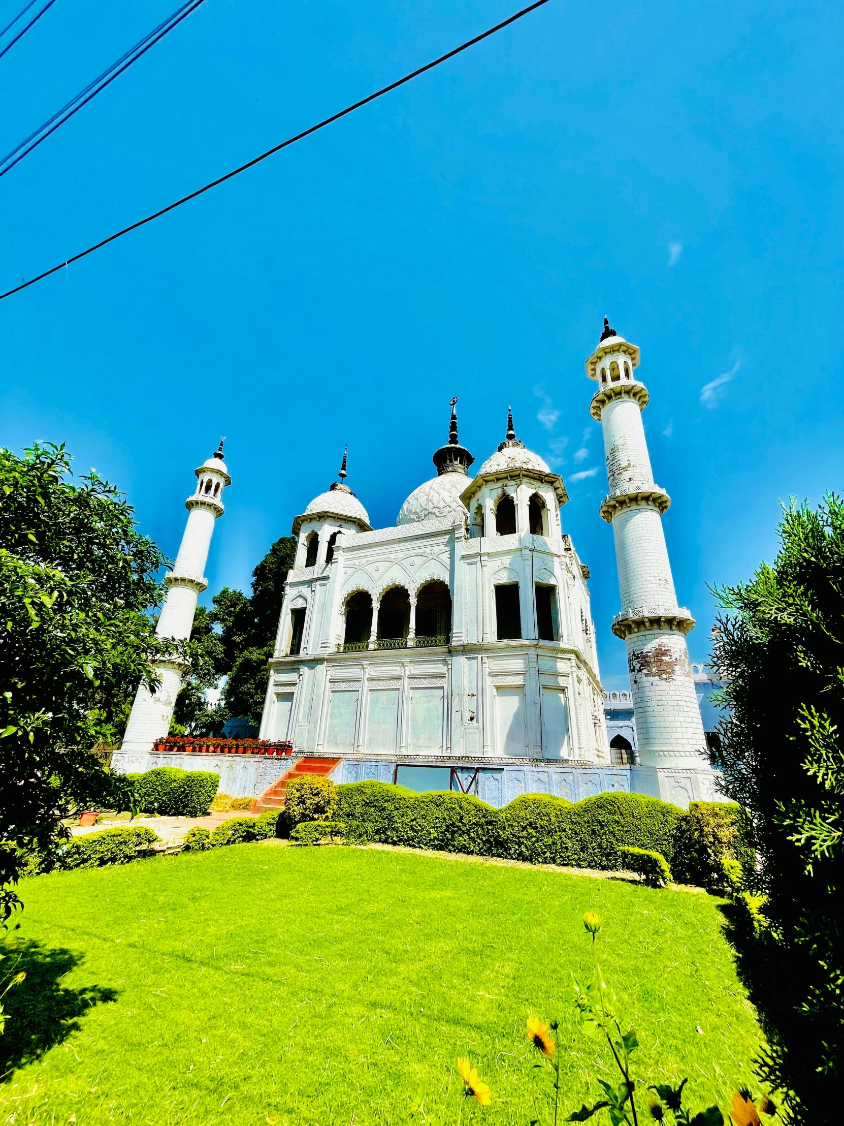 an old church sits on top of a hill surrounded by trees