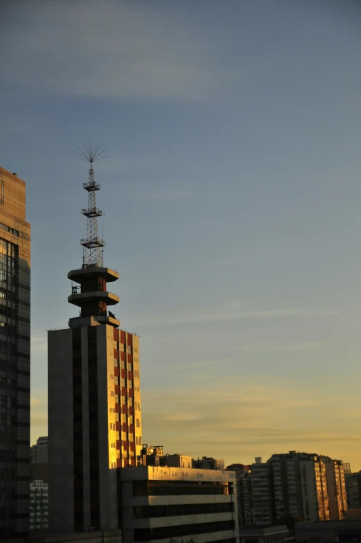 an airplane is flying in the sky over buildings