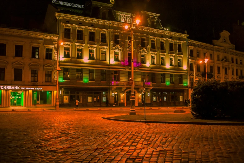 a large building lit up at night in a city