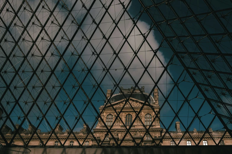 a building behind a large pyramid made out of squares