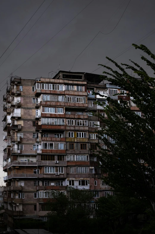 a tall brown building has lots of windows