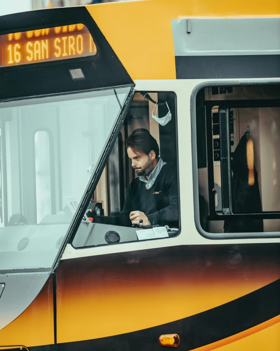 a man looking out the window of a commuter train