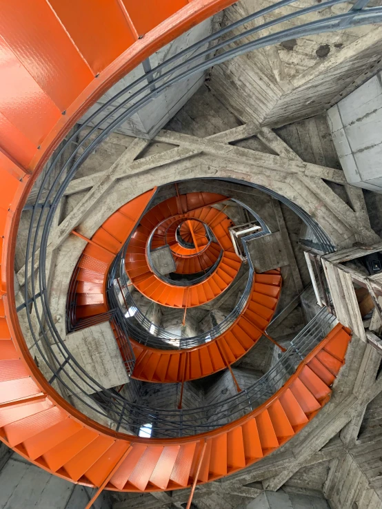 looking down at an orange spiral stair case