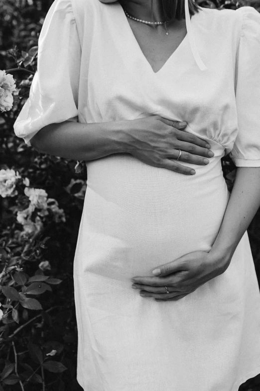 an image of a pregnant woman wearing a dress