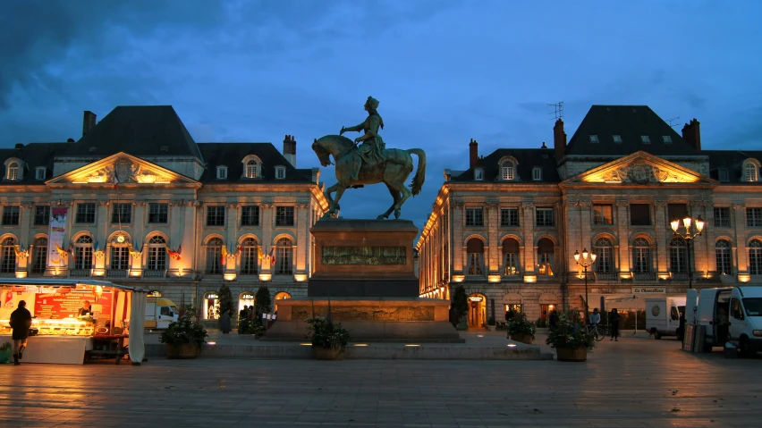 the lights are on at night in a large town square