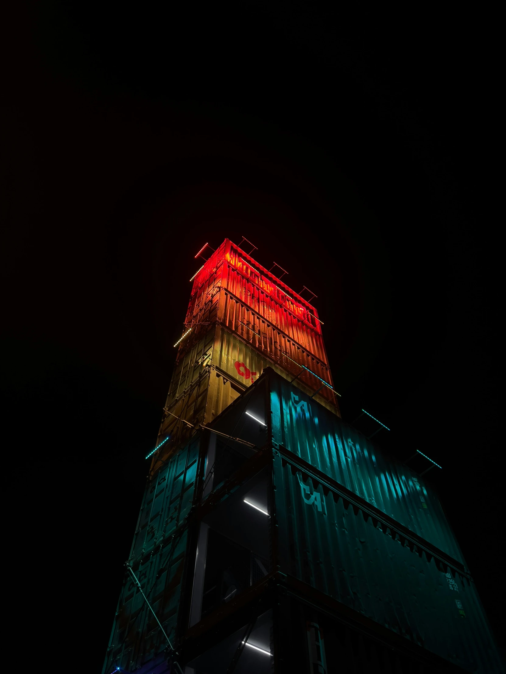 a tall tower lit up with a lot of colors