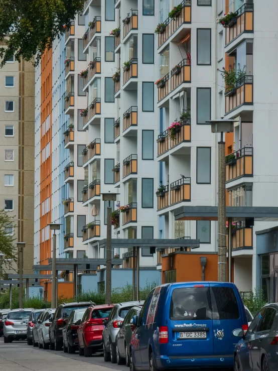 blue truck parked on side of a street next to tall building