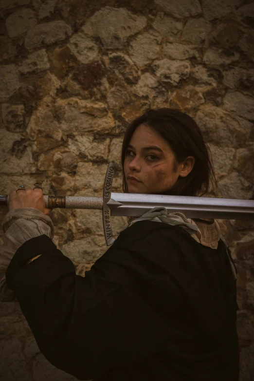 a woman holding onto a pole and looking at the camera